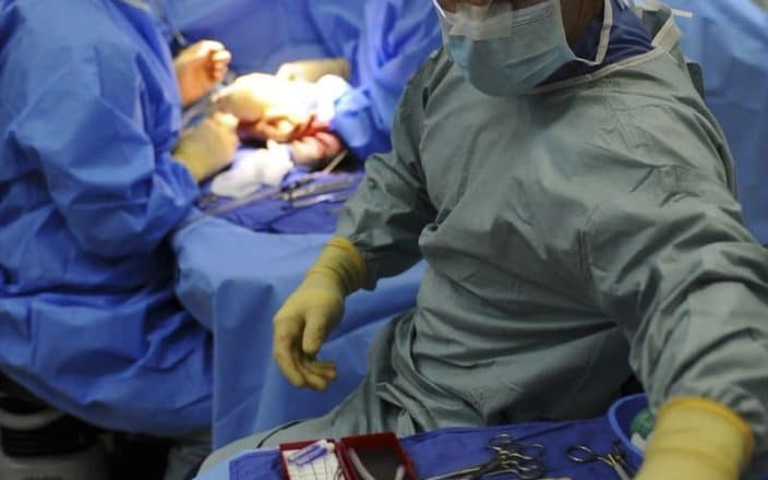 Doctors Performing Surgery In Hospital
